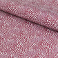 a sheet of wrapping paper in aubergine with a white abstract pattern