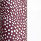 a sheet of wrapping paper in aubergine with a white abstract pattern