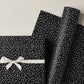 a sheet of black wrapping paper with a white speckle pattern