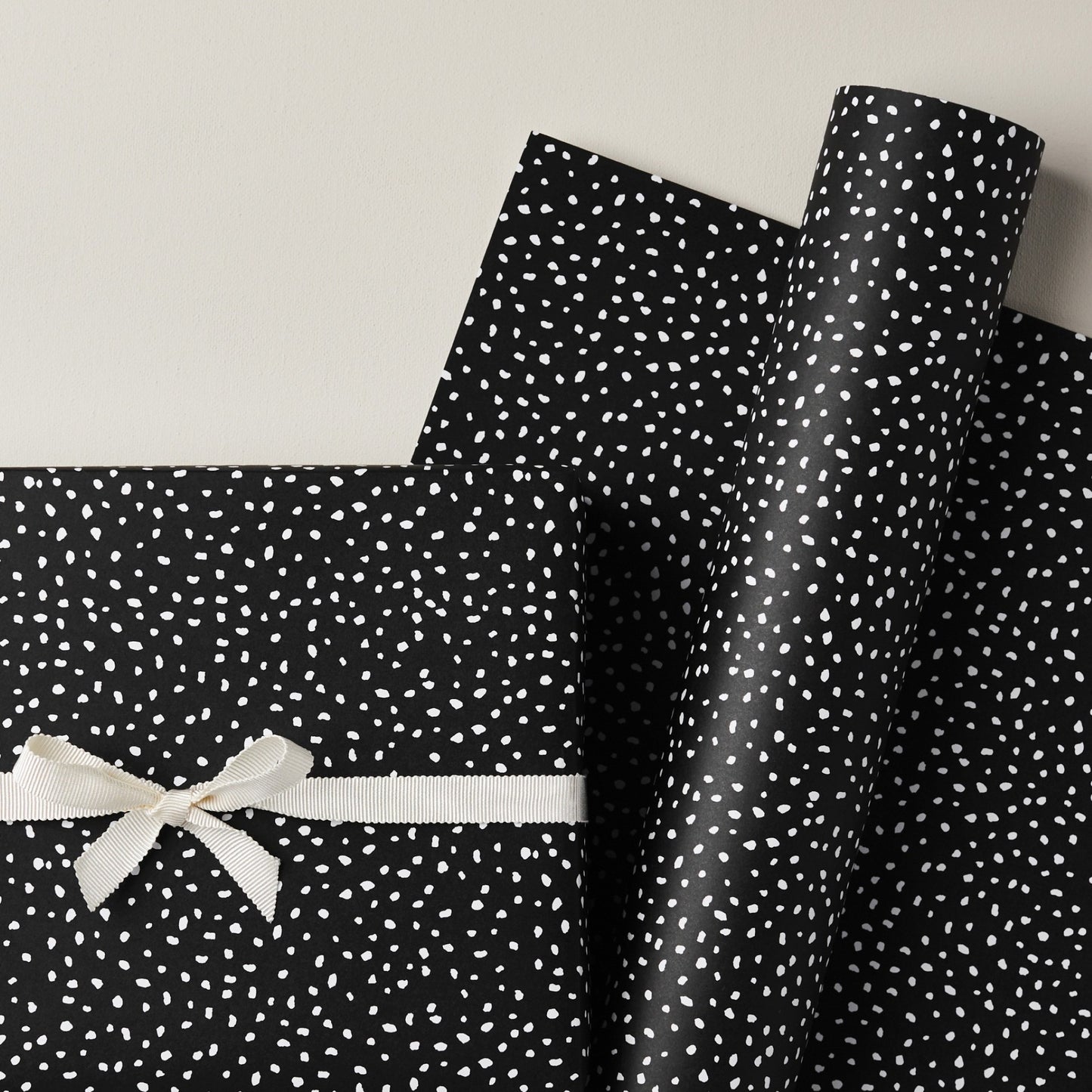 a sheet of black wrapping paper with a white speckle pattern