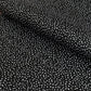 a sheet of black wrapping paper with a white speckle pattern
