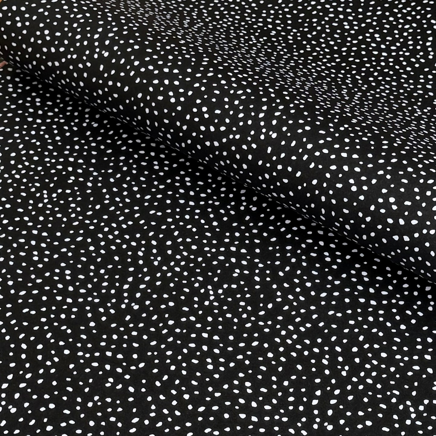 a sheet of black wrapping paper with a white speckle pattern