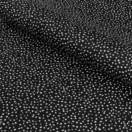 a sheet of black wrapping paper with a white speckle pattern