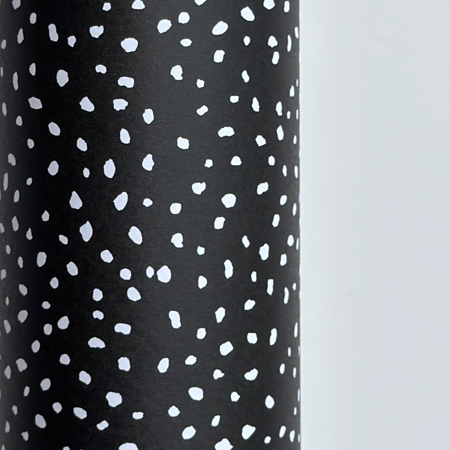 a sheet of black wrapping paper with a white speckle pattern
