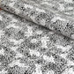 a sheet of wrapping paper with a black floral design on white