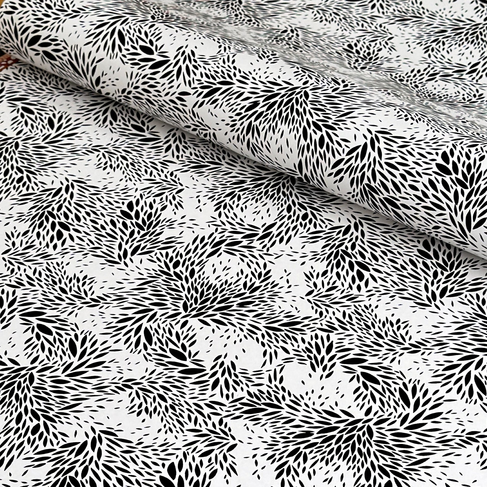 a sheet of wrapping paper with a black floral design on white