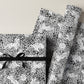 a sheet of wrapping paper with a black floral design on white