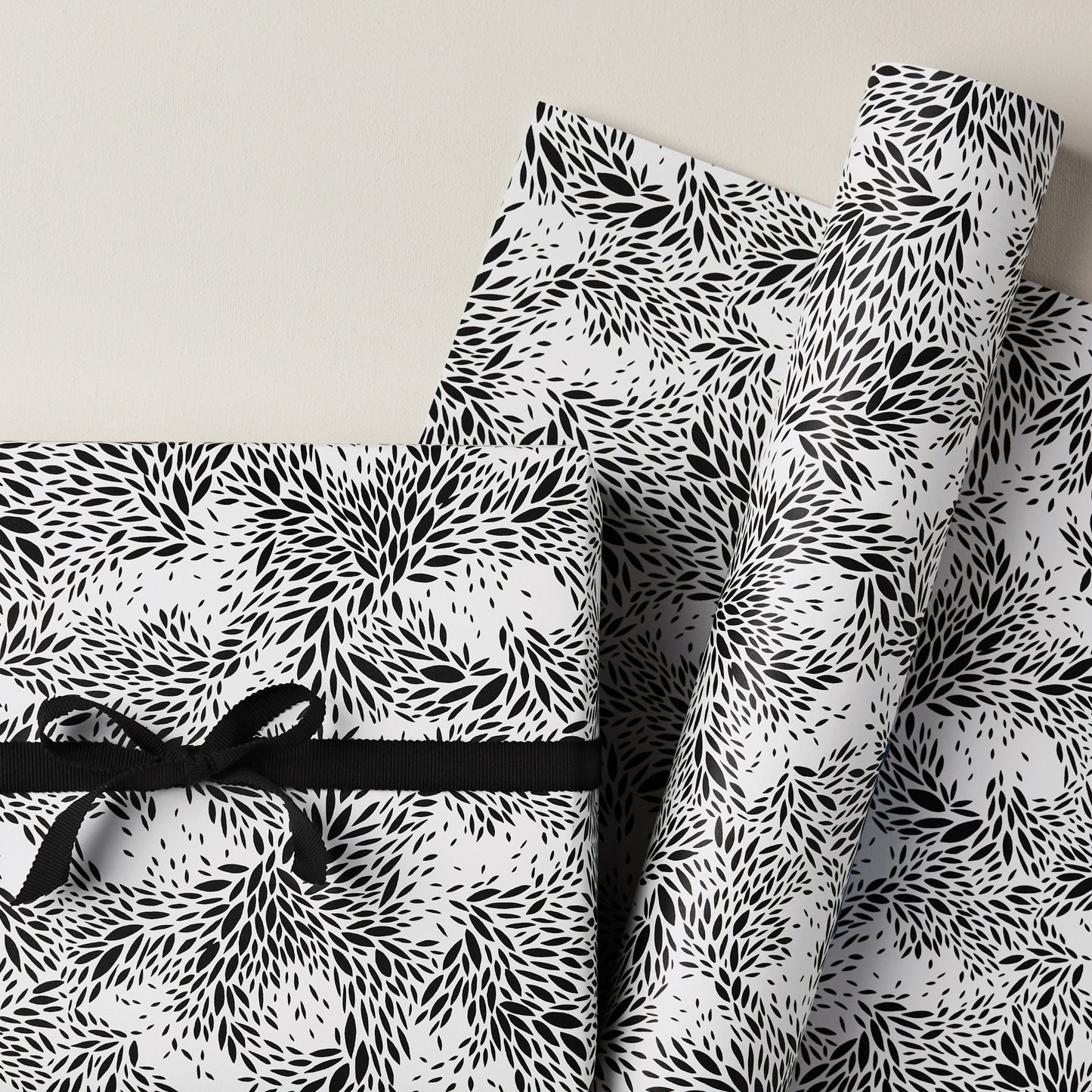 a sheet of wrapping paper with a black floral design on white