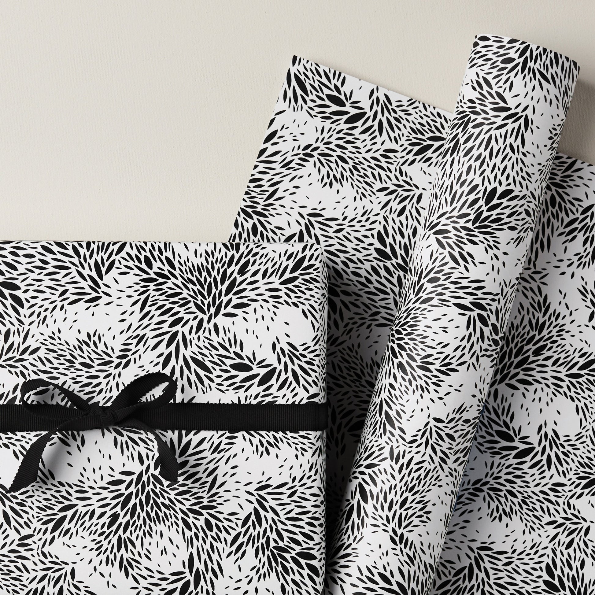 a sheet of wrapping paper with a black floral design on white