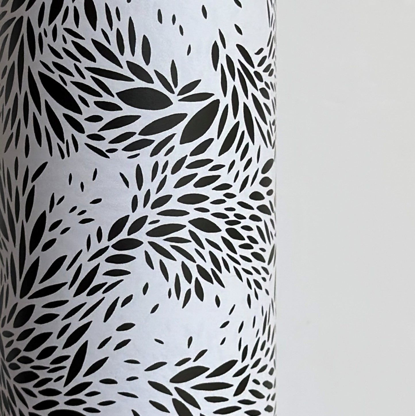 a sheet of wrapping paper with a black floral design on white