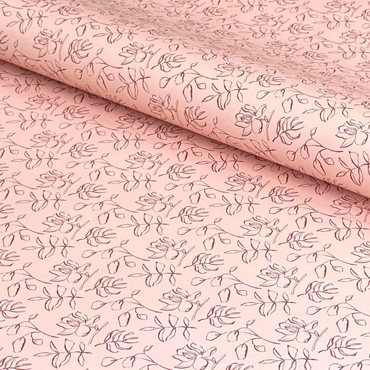 a sheet of wrapping paper in blush pink with a floral sketched pattern in brown