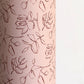 a sheet of wrapping paper in blush pink with a floral sketched pattern in brown