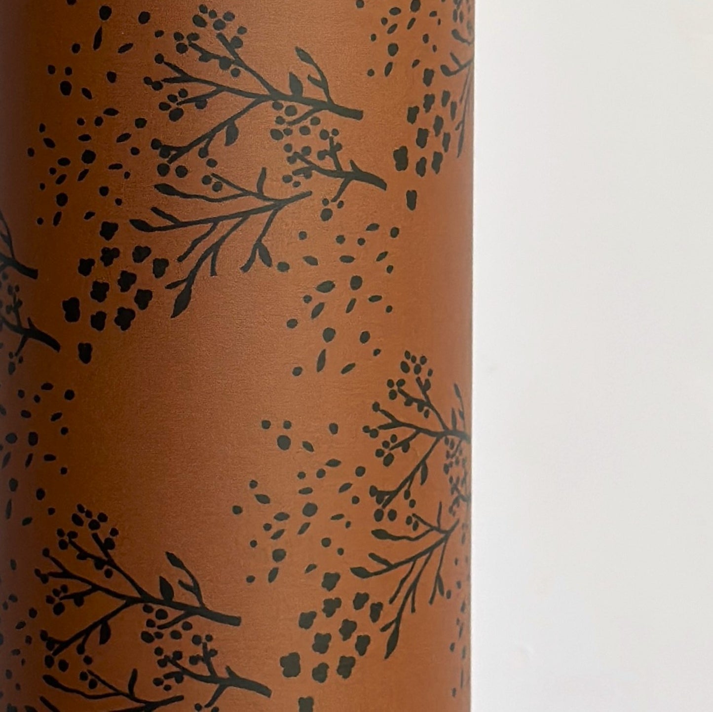 a sheet of brown wrapping paper with an abstract floral pattern in black