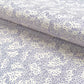 a sheet of wrapping paper in white with a blue speckle design