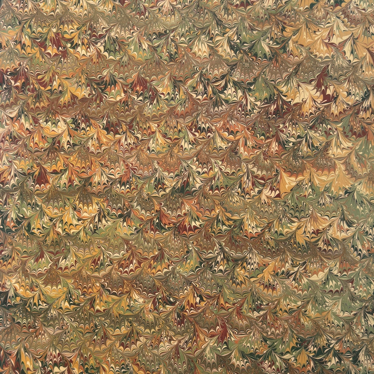 printed marbled wrapping paper by Jemma Lewis with a marbled pattern in brown, green and yellow autumnal tones