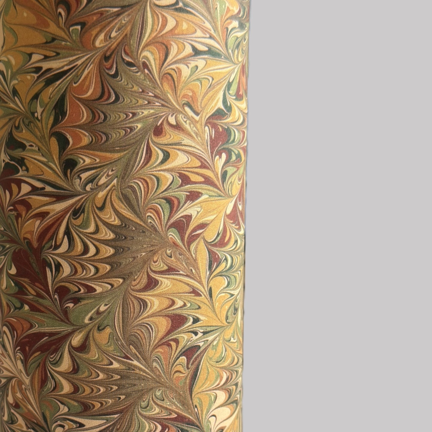 printed marbled wrapping paper by Jemma Lewis with a marbled pattern in brown, green and yellow autumnal tones. close up