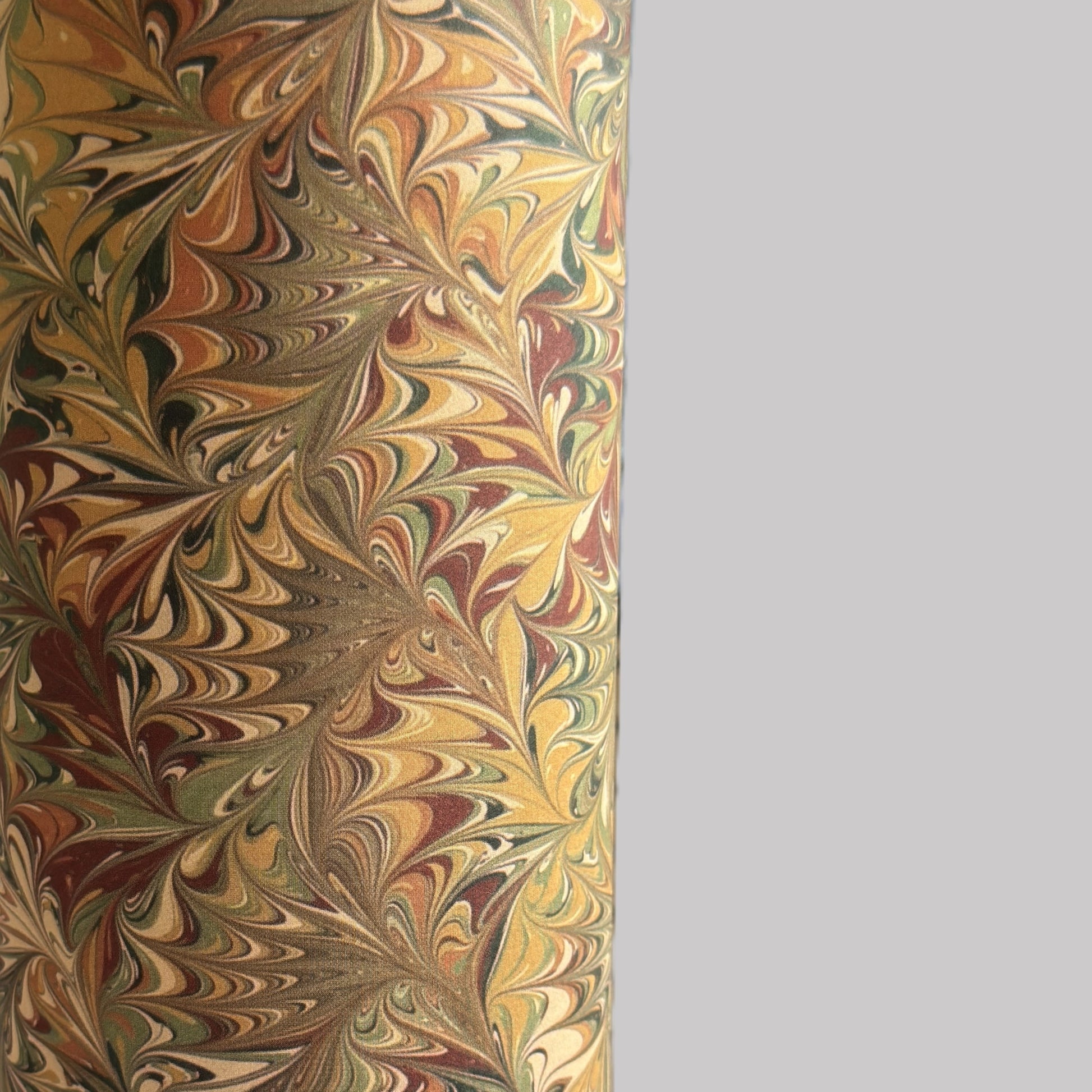 printed marbled wrapping paper by Jemma Lewis with a marbled pattern in brown, green and yellow autumnal tones. close up