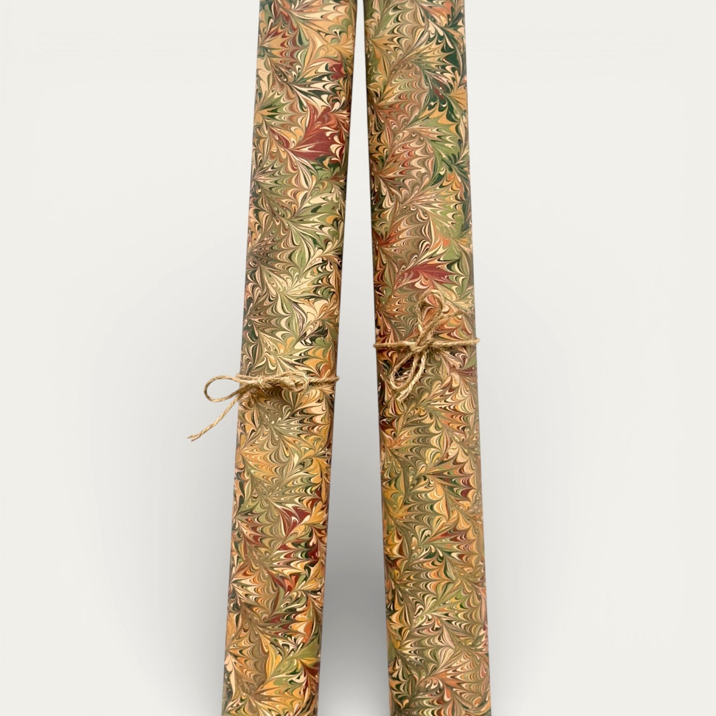 printed marbled wrapping paper by Jemma Lewis with a marbled pattern in brown, green and yellow autumnal tones. rolled