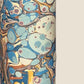 printed marbled wrapping paper by Jemma Lewis with a marbled pattern in blue, yellow, brown and cream. close up