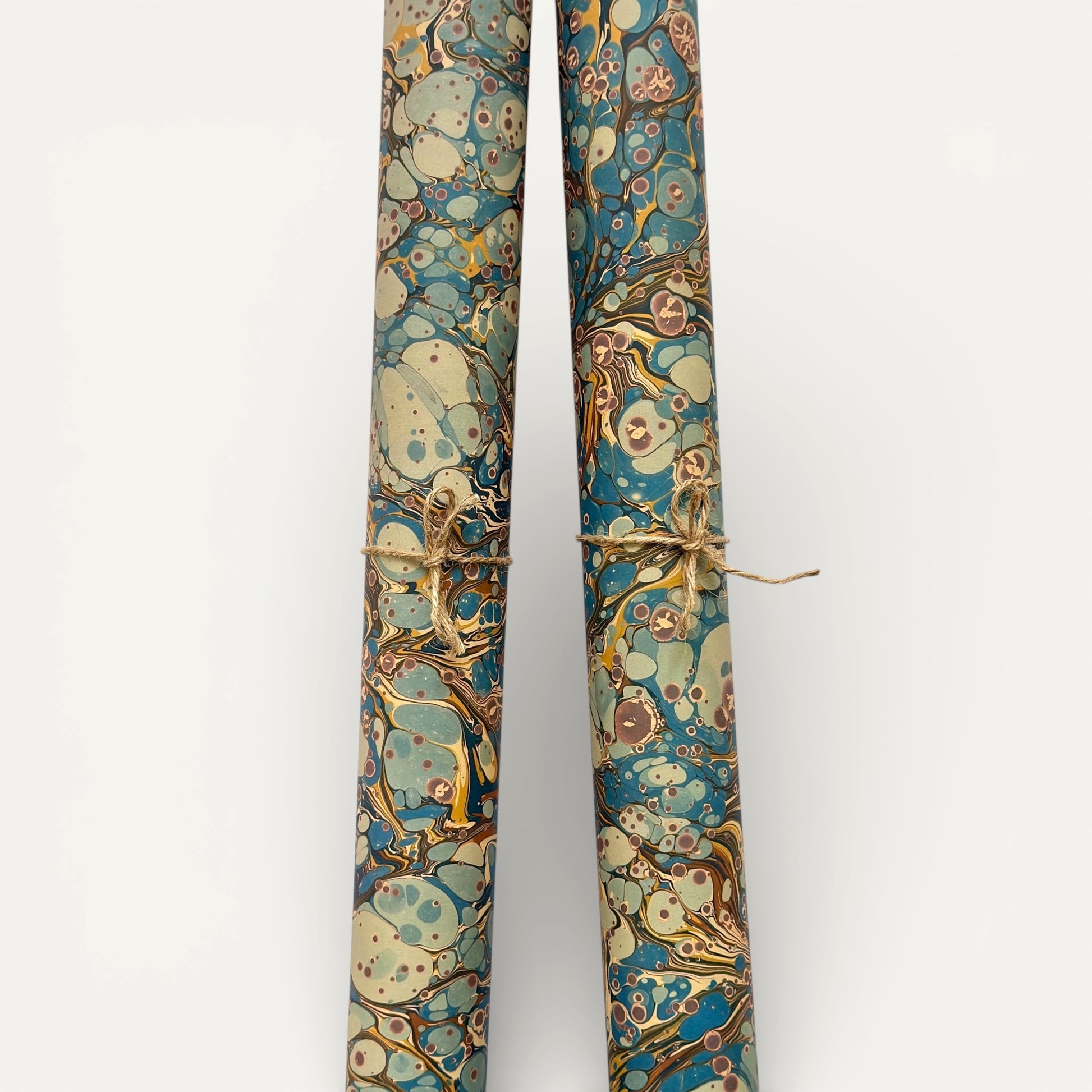 printed marbled wrapping paper by Jemma Lewis with a marbled pattern in blue, yellow, brown and cream. Rolled