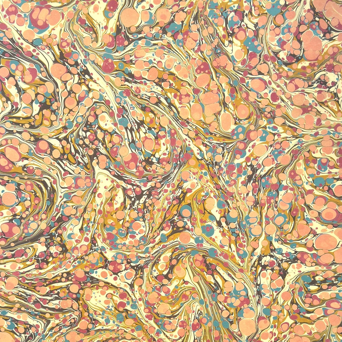 printed marbled wrapping paper by Jemma Lewis with a marbled pattern in blush pink, mustard, pale blue, brown and raspberry
