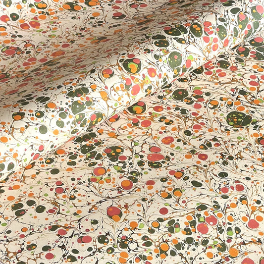 Printed marbled wrapping paper by Jemma Lewis Marbling. Marbled paper in bright yellow, pink and green on white backdrop.