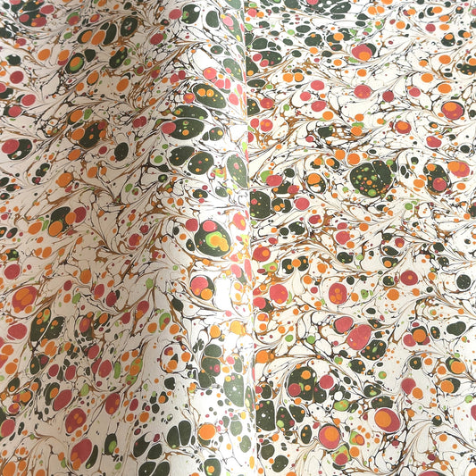Printed marbled wrapping paper by Jemma Lewis Marbling. Marbled paper in bright yellow, pink and green on white backdrop.