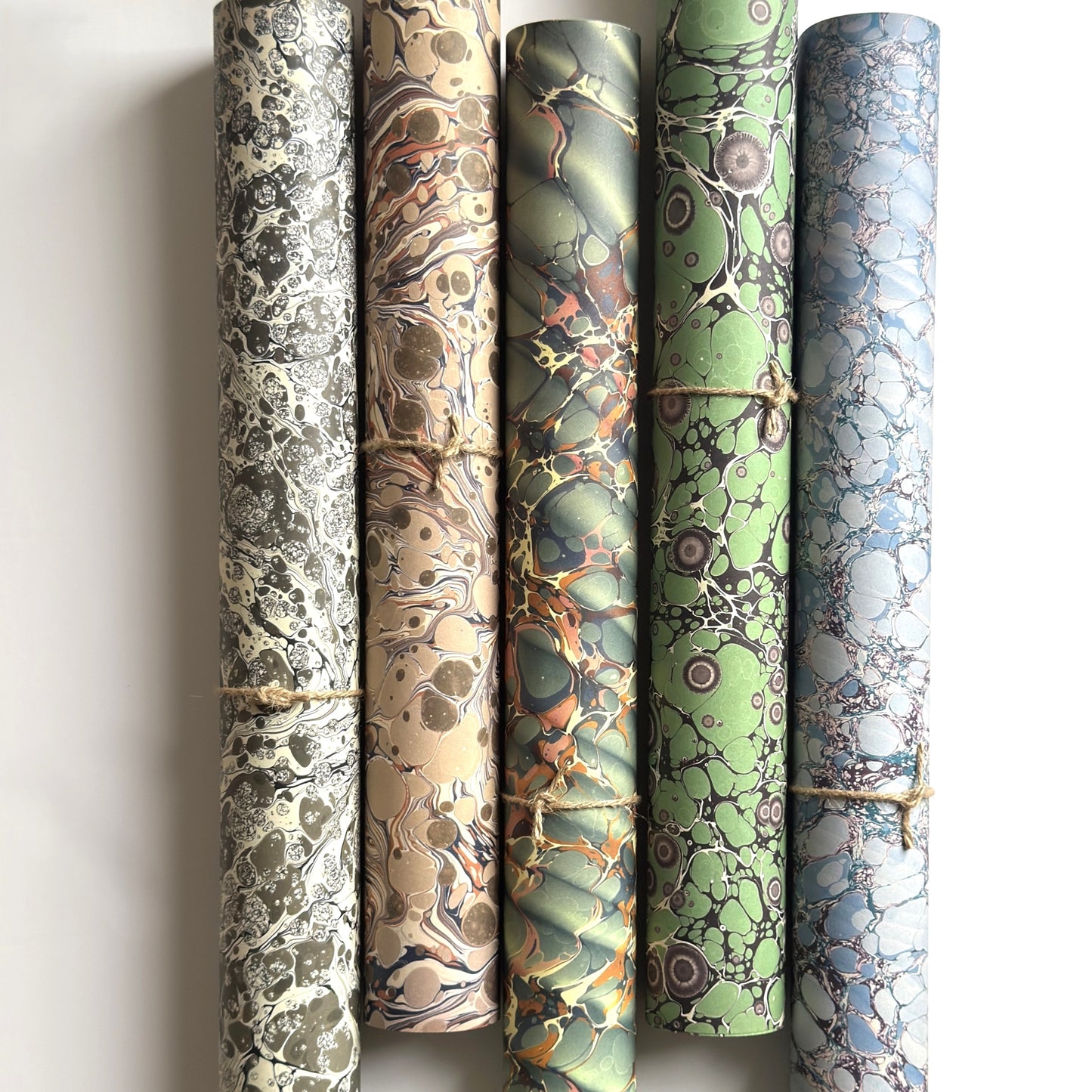 rolls of printed marbled wrapping papers by Jemma Lewis in different patterns