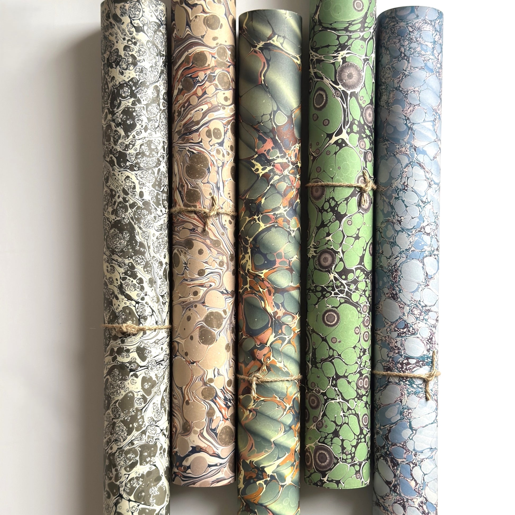 rolls of printed marbled wrapping papers by Jemma Lewis in different patterns