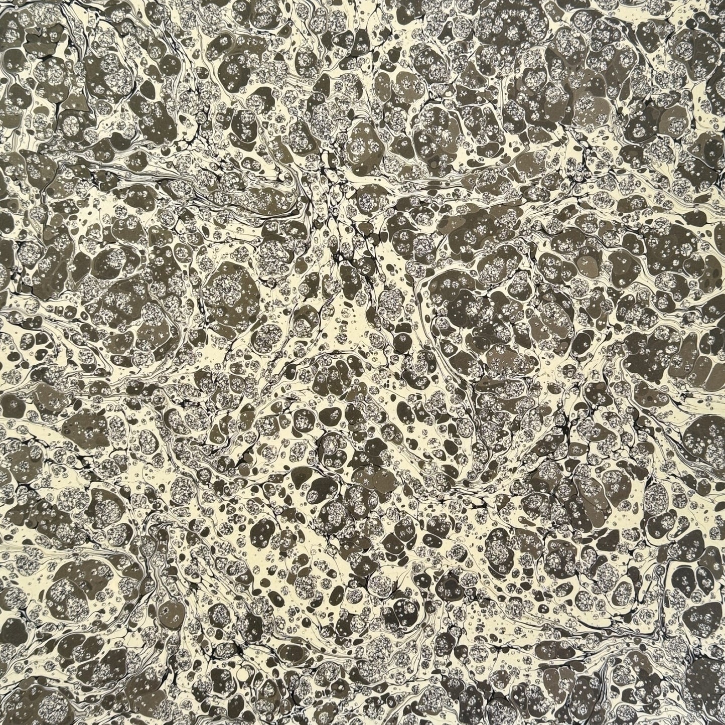 sheet of printed marbled wrapping paper by Jemma Lewis, stone effect in taupe, black and beige