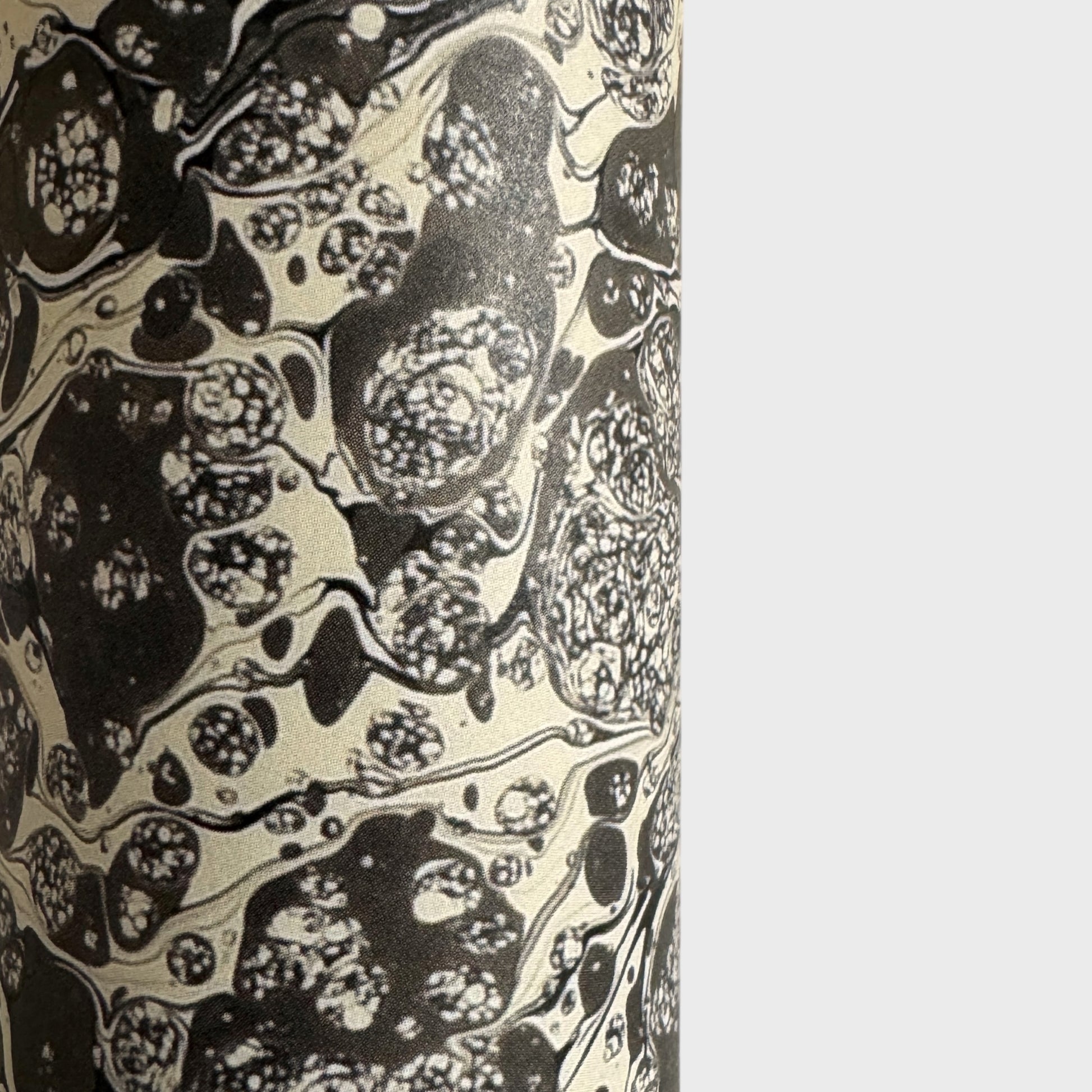 sheet of printed marbled wrapping paper by Jemma Lewis, stone effect in taupe, black and beige. Close up