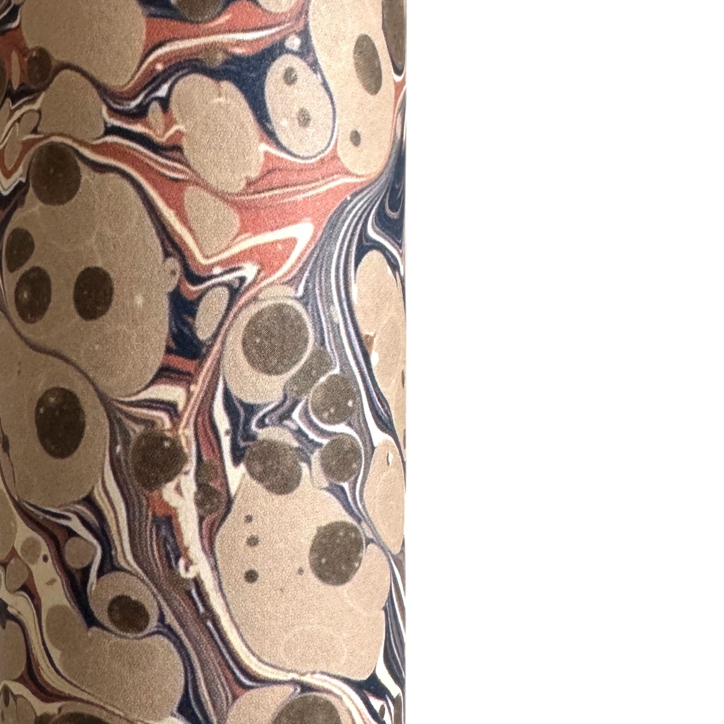 sheet of printed marbled wrapping paper by Jemma Lewis, stone effect in taupe, blush pink and beige. Close up