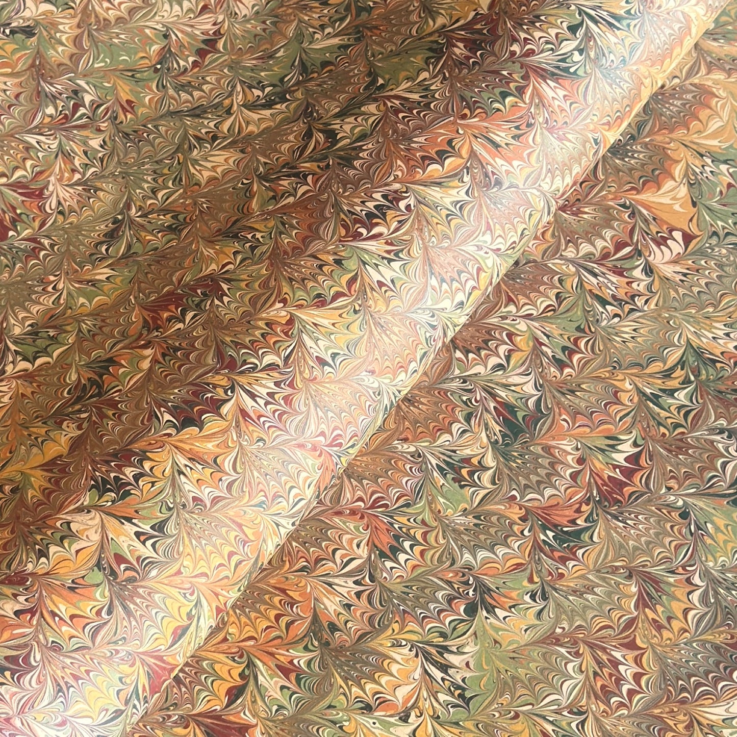 printed marbled wrapping paper by Jemma Lewis with a marbled pattern in brown, green and yellow autumnal tones