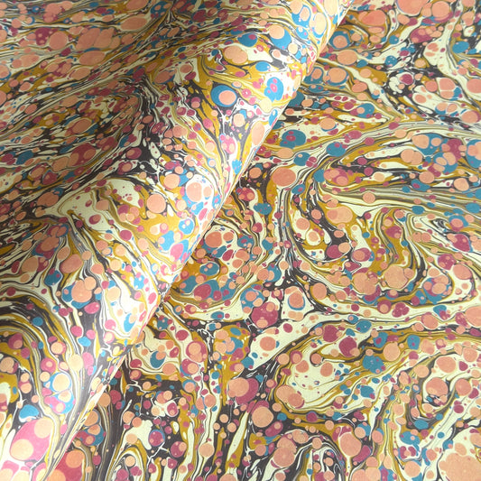 printed marbled wrapping paper by Jemma Lewis with a marbled pattern in blush pink, mustard, pale blue, brown and raspberry.
