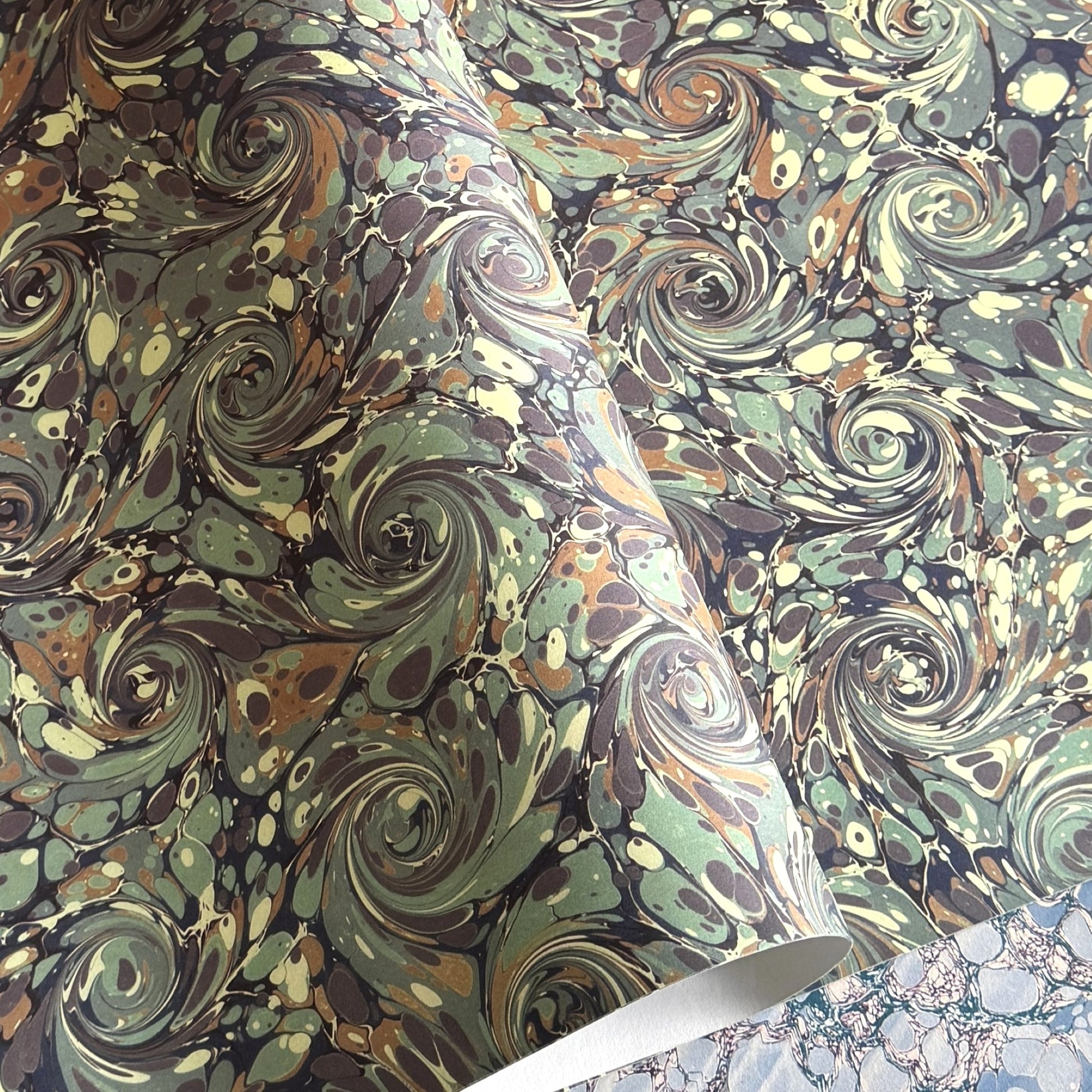 printed marble design wrapping paper by Jemma Lewis. Swirl design in inky greys and lichen greens