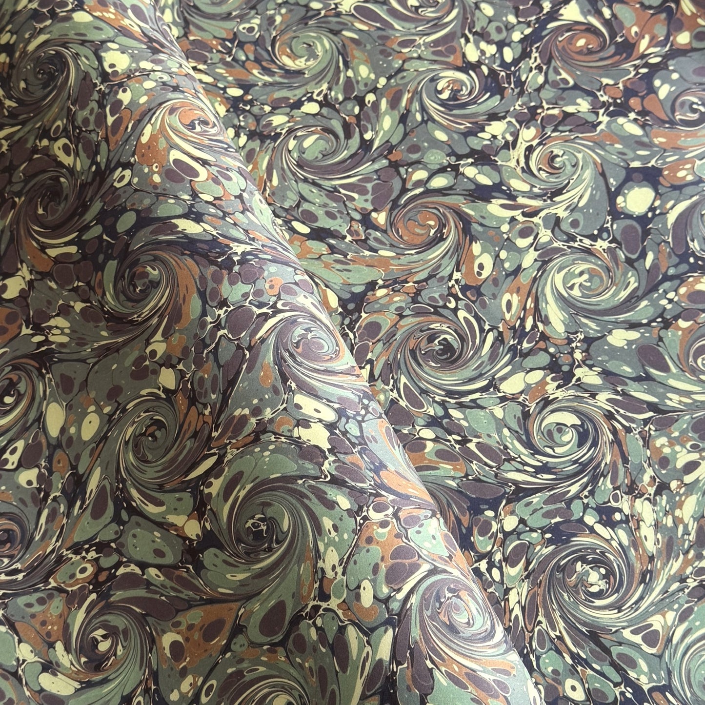 printed marble design wrapping paper by Jemma Lewis. Swirl design in inky greys and lichen greens