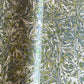 Printed marbled wrapping paper by Jemma Lewis Marbling. Marbled paper with a shimmery base paper and marbled pattern in green, lime and white