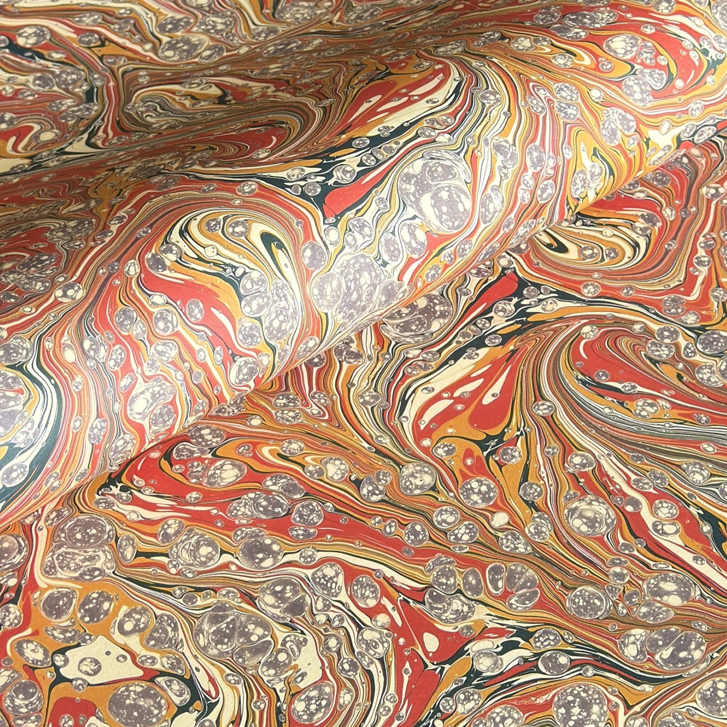 printed marbled design wrapping paper by jemma lewis.  marbled stone design in red, yellow and grey