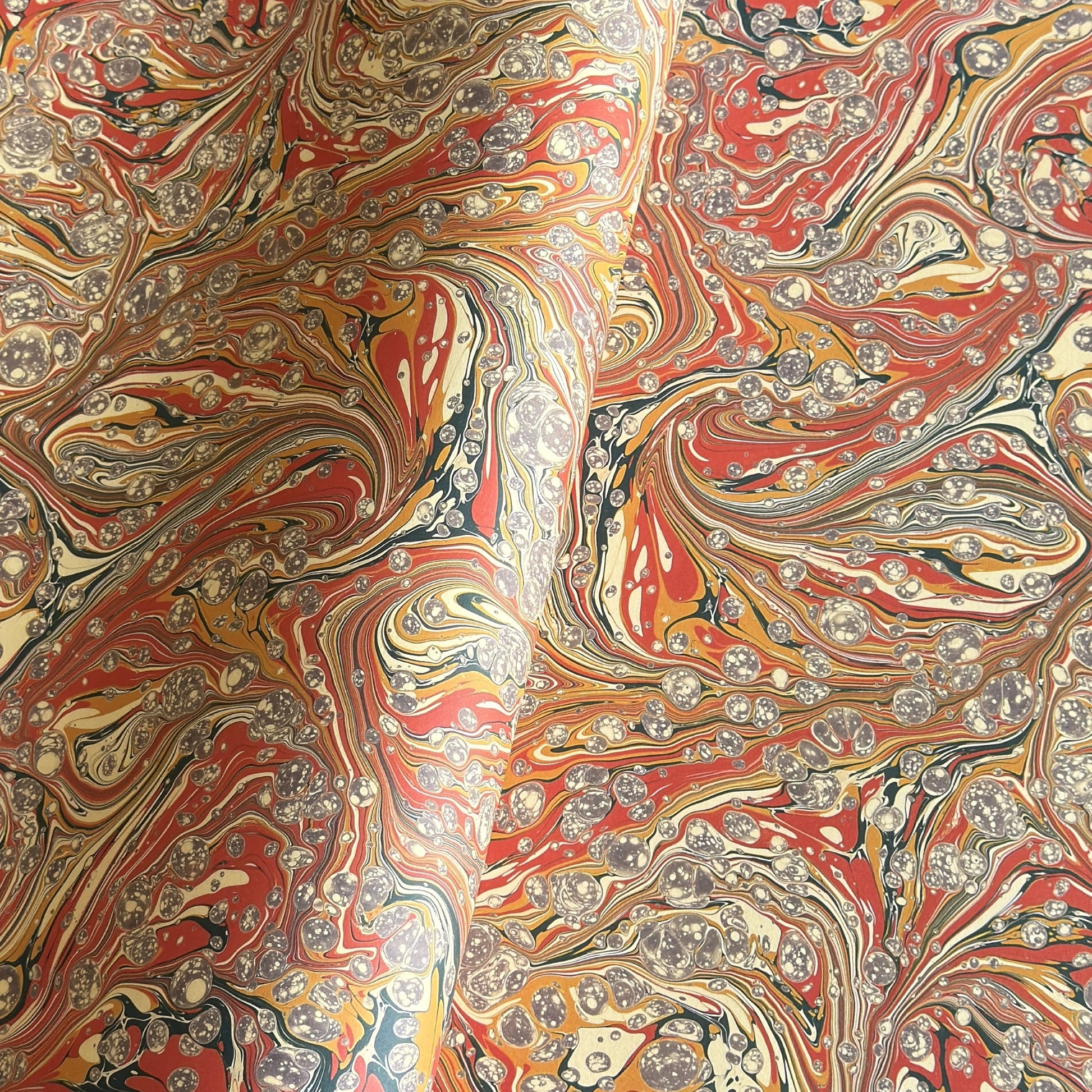 printed marbled design wrapping paper by jemma lewis.  marbled stone design in red, yellow and grey