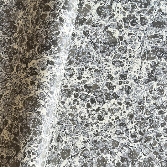 sheet of printed marbled wrapping paper by Jemma Lewis, stone effect in taupe, black and beige. 