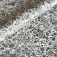 sheet of printed marbled wrapping paper by Jemma Lewis, stone effect in taupe, black and beige. 
