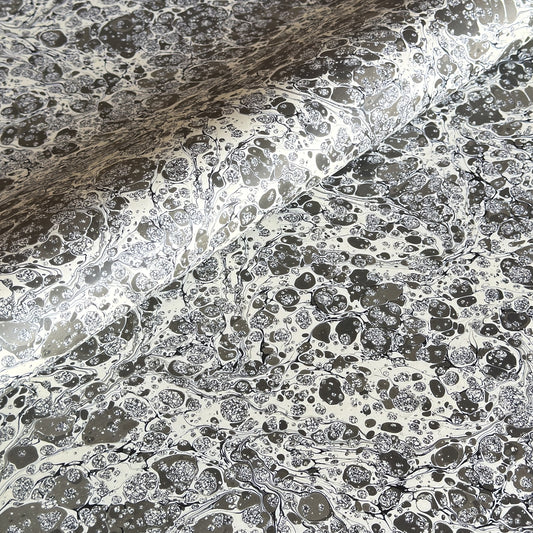 sheet of printed marbled wrapping paper by Jemma Lewis, stone effect in taupe, black and beige. 