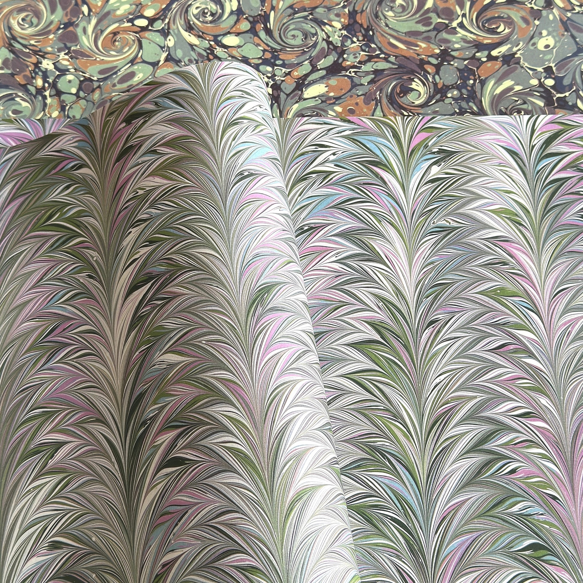 printed marbled design wrapping paper by Jemma Lewis, a feathered marble in green and lilac 