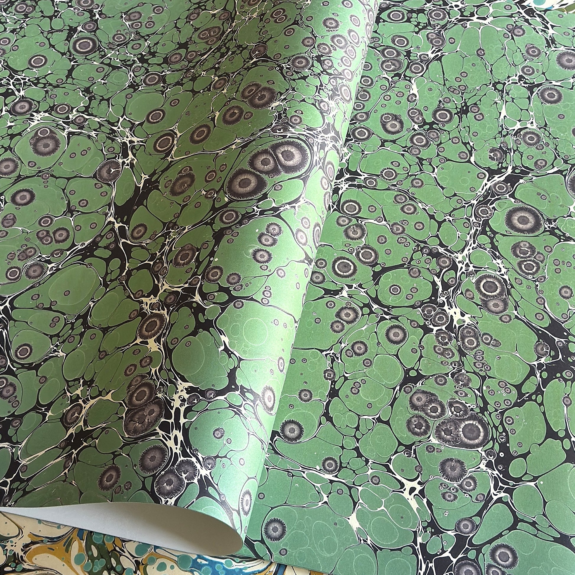 sheet of printed marbled wrapping paper by Jemma Lewis, stone effect in green and grey