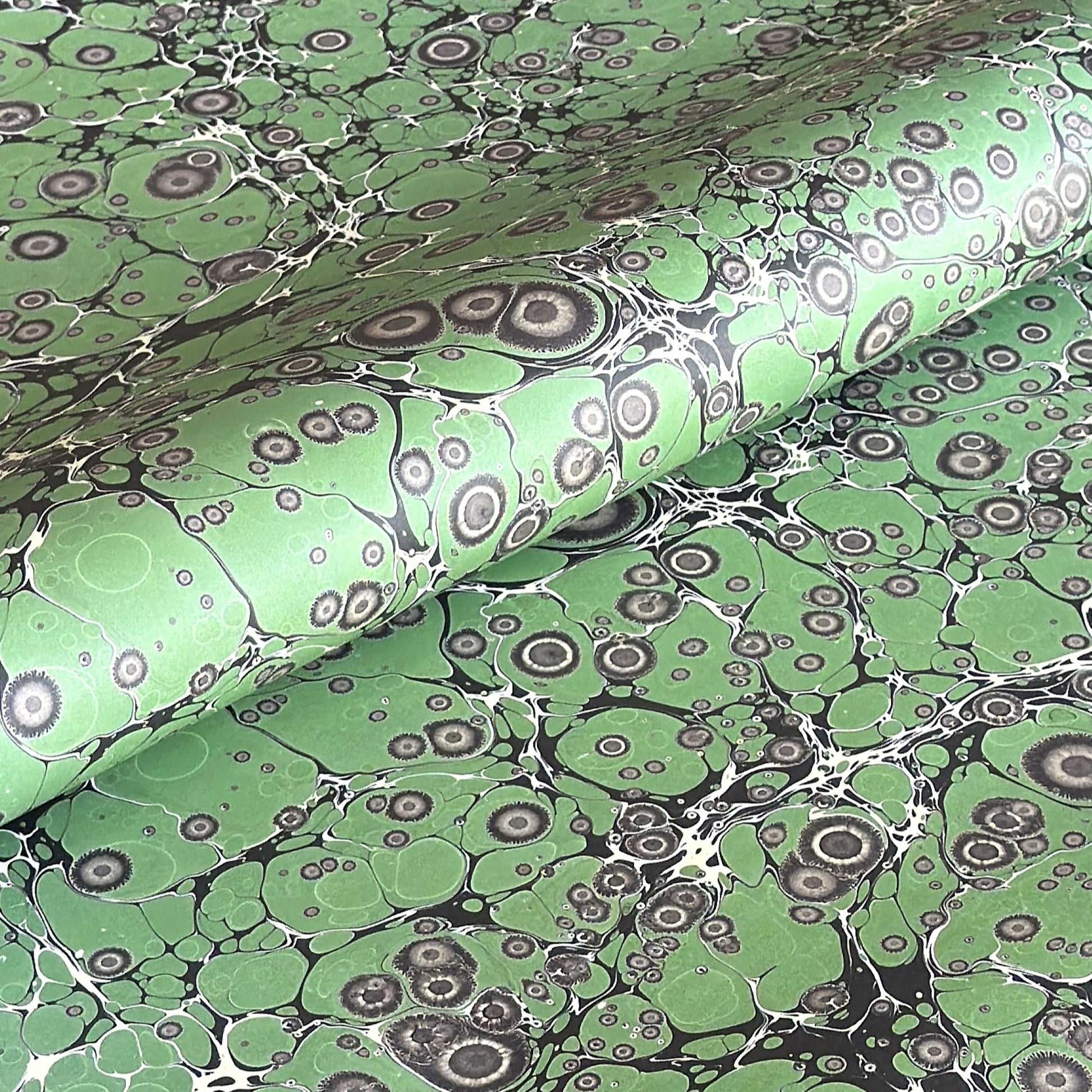 sheet of printed marbled wrapping paper by Jemma Lewis, stone effect in green and grey