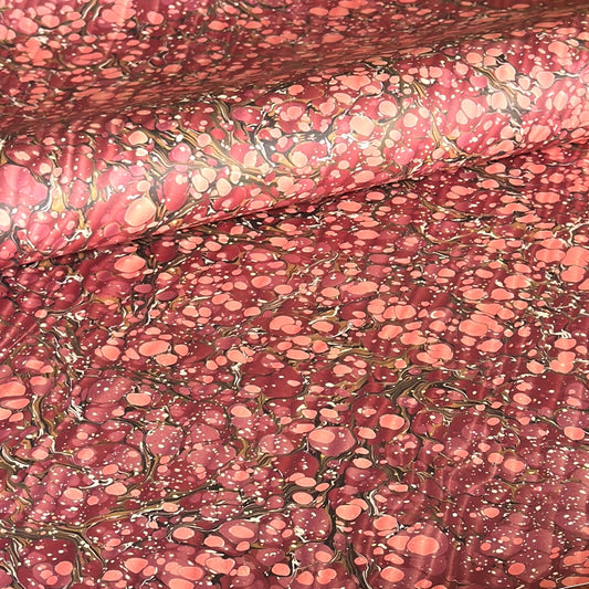 Printed marbled wrapping paper by Jemma Lewis Marbling. Marbled paper in deep burgundy, pinks and brown