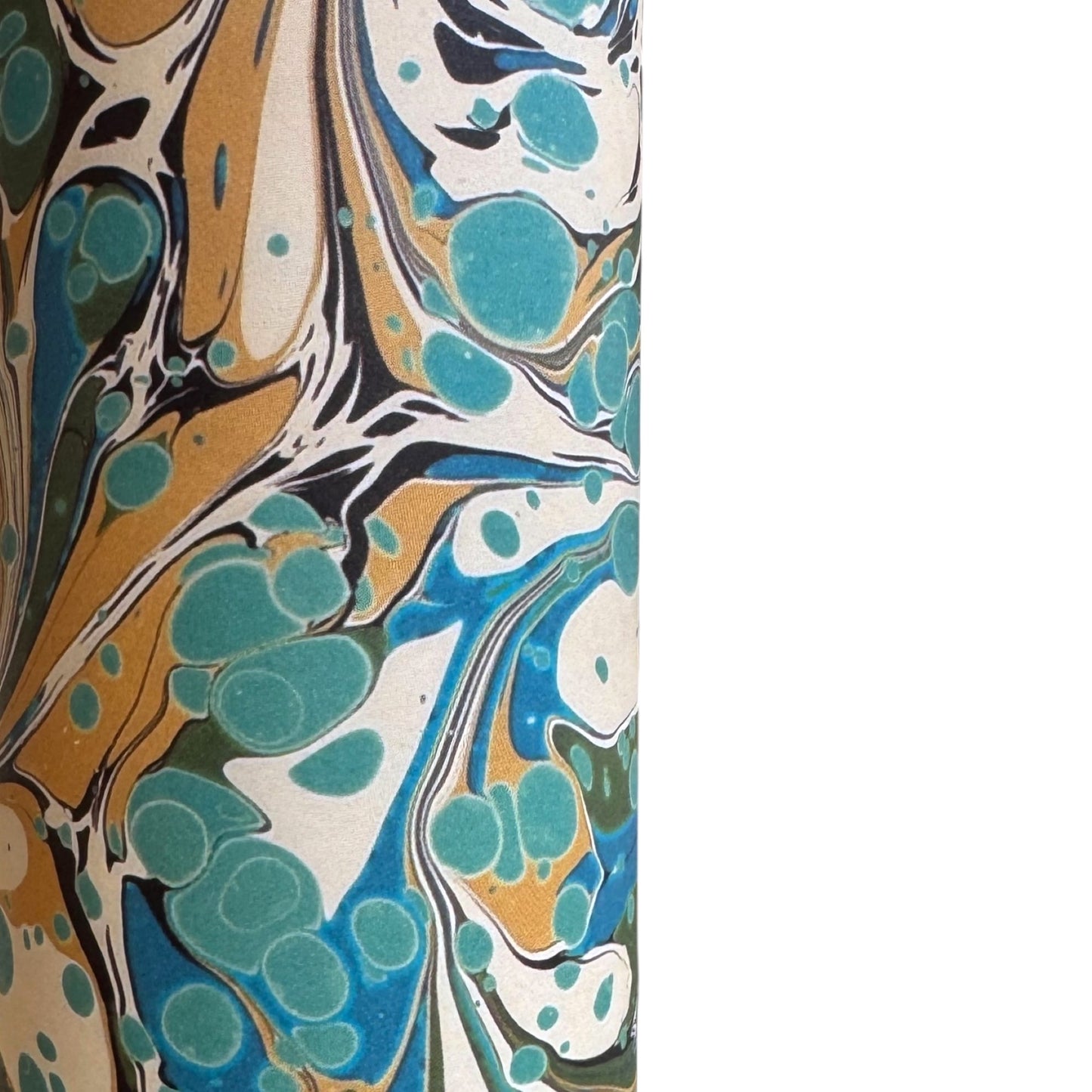 printed marbled wrapping paper with marbled pattern in aqua, blue, sand and cream. Close up