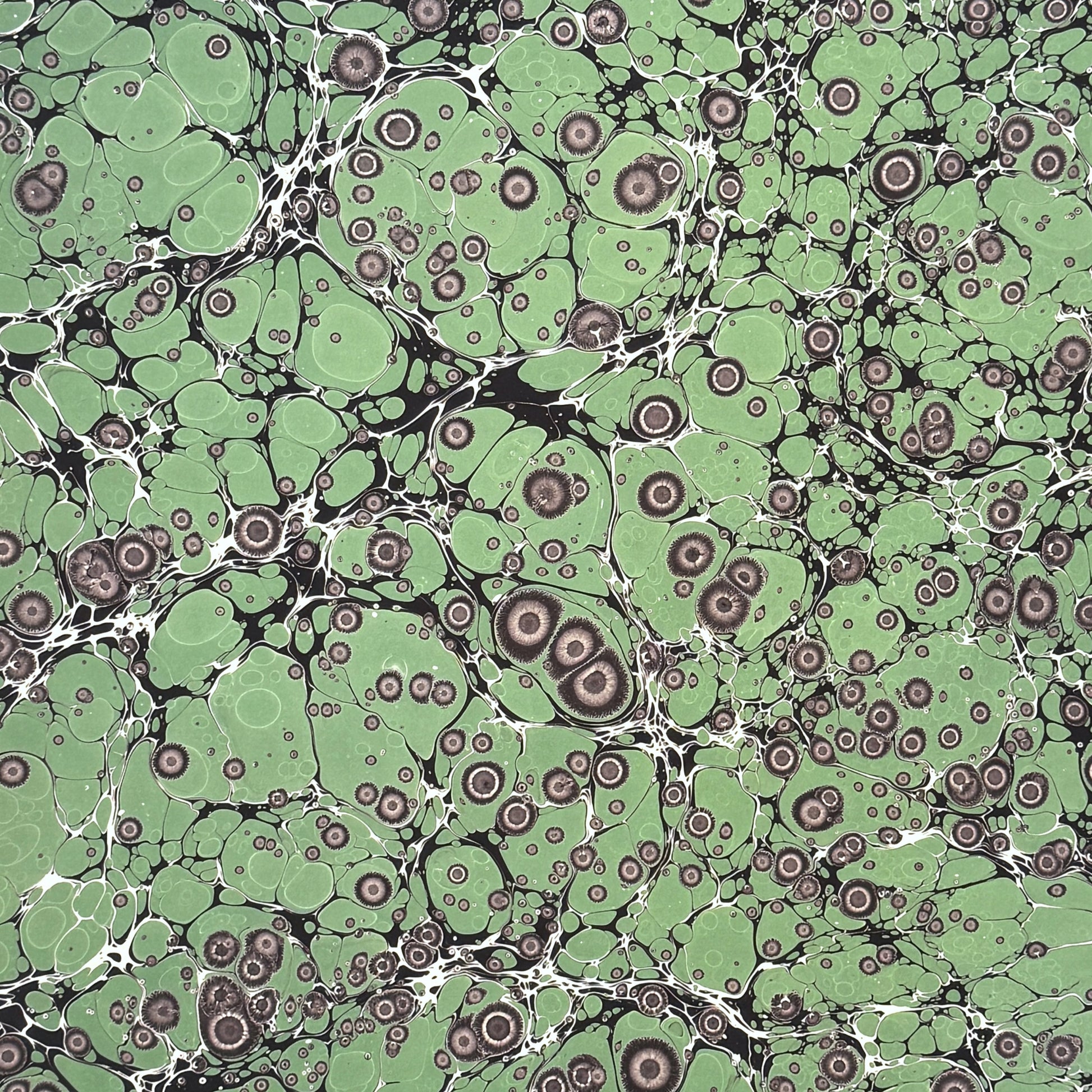 sheet of printed marbled wrapping paper by Jemma Lewis, stone effect in green and grey