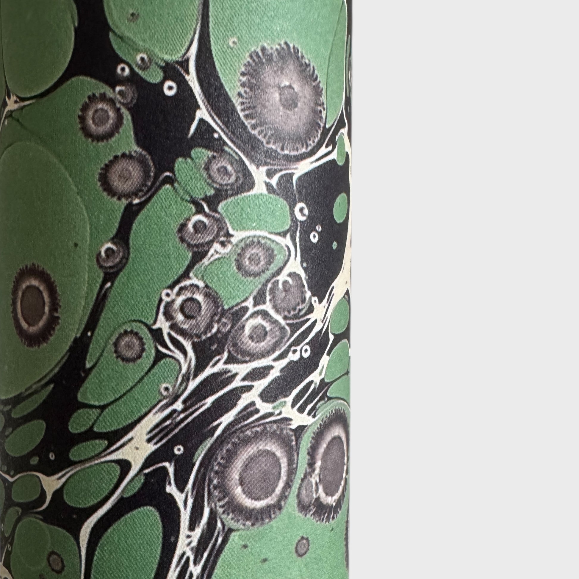 sheet of printed marbled wrapping paper by Jemma Lewis, stone effect in green and grey. Close up