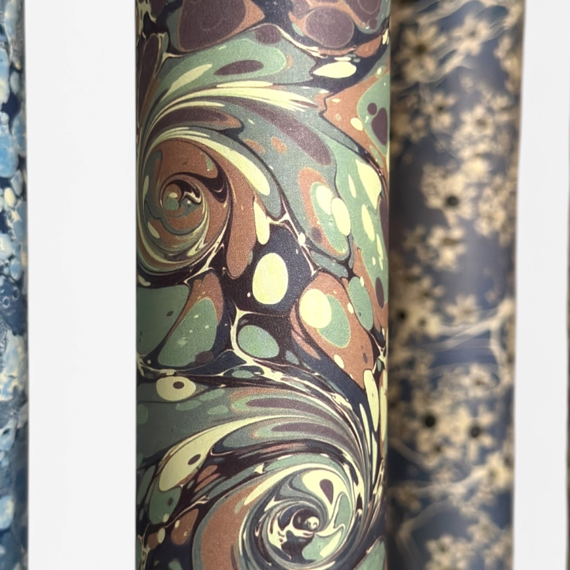 printed marble design wrapping paper by Jemma Lewis. Swirl design in inky greys and lichen greens. Close-up